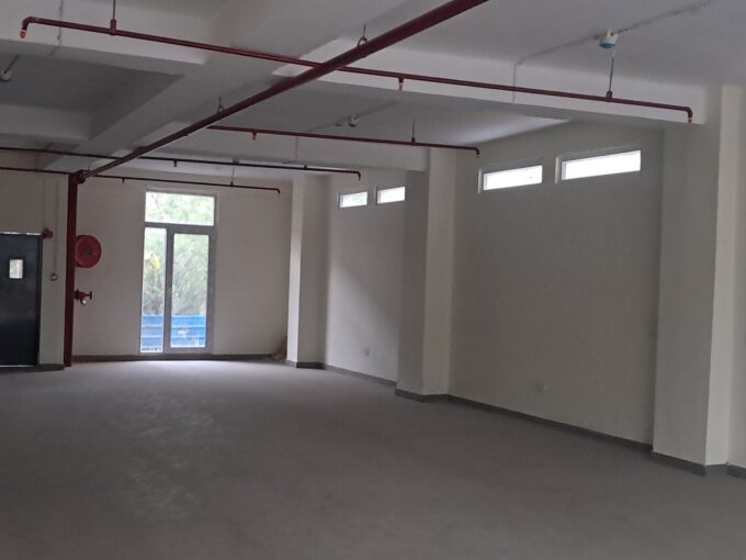 Spacious ground floor warehouse available for rent with wide loading access in Okhla Industrial Area.